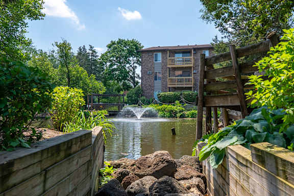 Outdoor pool with lounge seating and courtyard views at TLC Grand Apartments, Illinois, 60015
