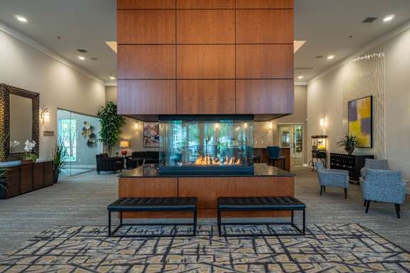 Swimming pool surrounded by modern apartment buildings at TLC Grand Apartments, Deerfield, IL 60015