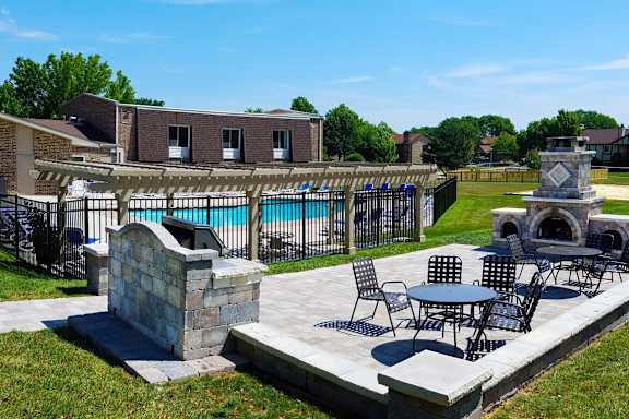Swimming pool surrounded by modern apartment buildings at TLC Grand Apartments, Deerfield, IL 60015