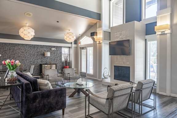 A modern living room with a dark brown couch and a glass coffee table.