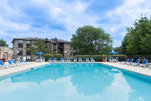 Outdoor pool with lounge seating and courtyard views at TLC Grand Apartments, Illinois, 60015