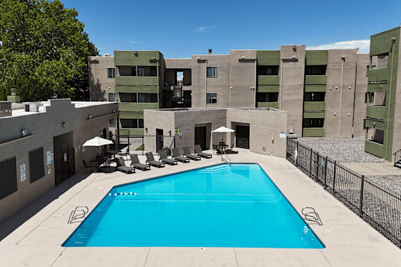 A swimming pool in front of a building.