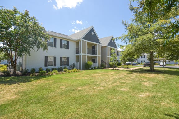 a large lawn in front of an apartment building at Reserve Of Bossier City Apartment Homes in Bossier City, Louisiana