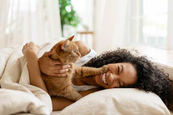 Woman Playing with Cat at One Rocky Ridge Apartment Homes in Douglasville, GA