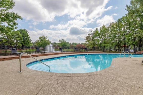 a swimming pool with trees and a fence around it at The Waters at Chenal, Little Rock, Arkansas