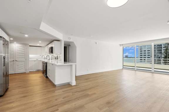 A modern kitchen with a refrigerator, sink, and countertops. at The Hamilton Apartments, Miami, FL 33137