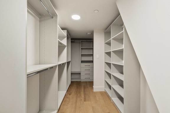 A white pantry with shelves and drawers. at The Hamilton Apartments, Miami, FL 33137