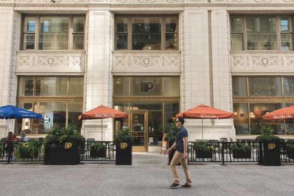 a man walking in front of a building