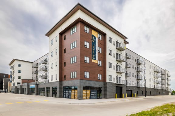 a large apartment building with a street in front of it at Northern Lights a Lifestyle-Driven Community, West Fargo, 58078