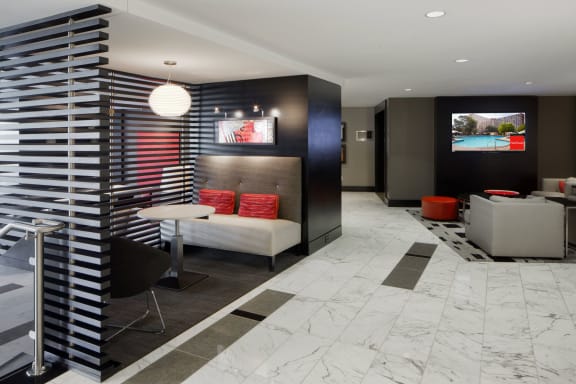 a lobby with a table and chairs and a television