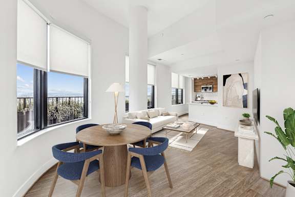 a living room with a wooden table and chairs and a couch