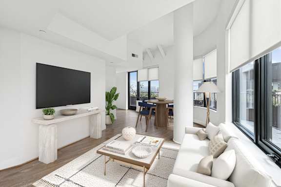 an open living room with a white couch and a television