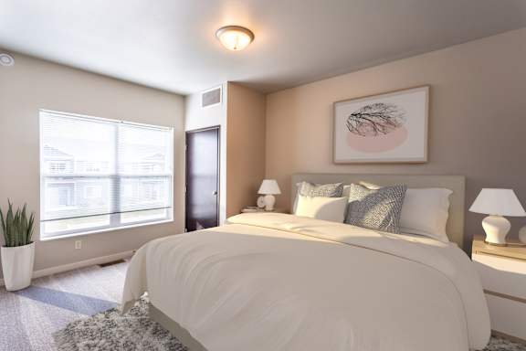 A bedroom with a large bed and a window with blinds.