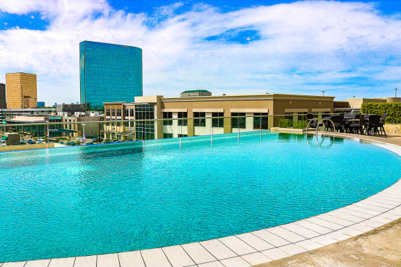 Large swimming pool with a city skyline at The Heights at Park Lane, Dallas, TX, Texas, 75231