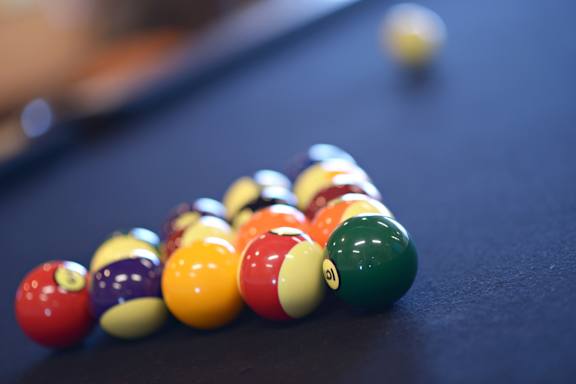 a pile of billiard balls on a pool table