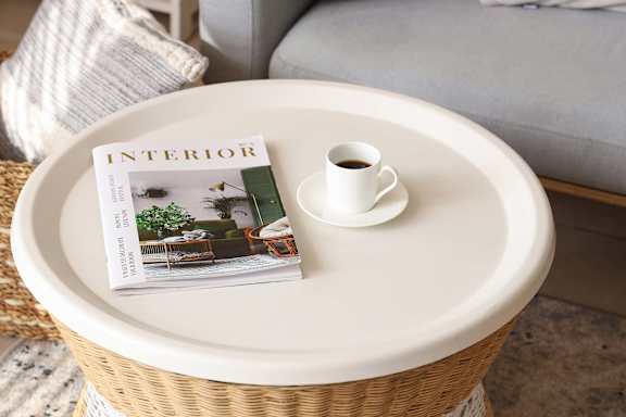Magazine on a table with a cup of coffee