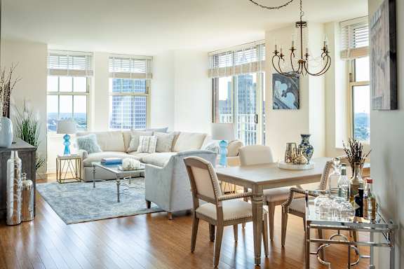 A living room with a white couch and a wooden table at Residences Providence, Rhode Island 2903