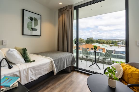 a hotel room with a bed and a balcony