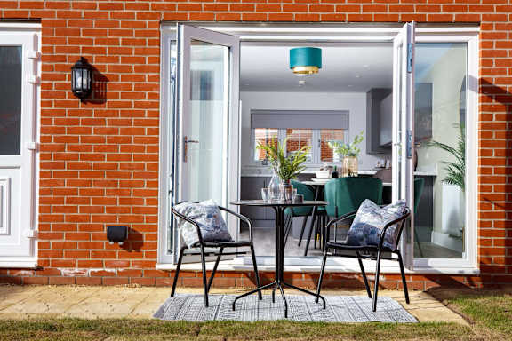 a small living room with a chair and a fireplace