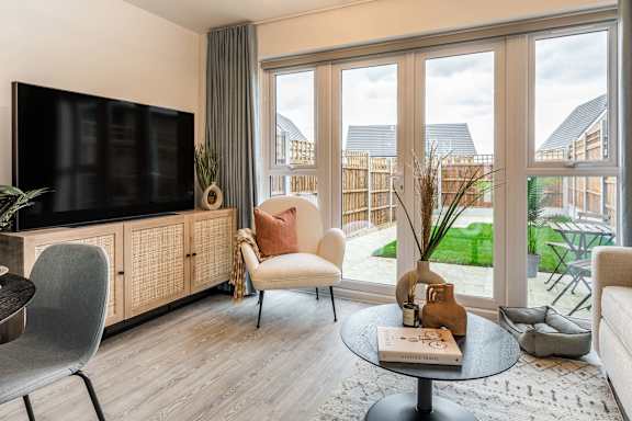 a small living room with a chair and a fireplace