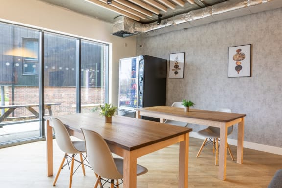 a dining room with a table and chairs and a large window