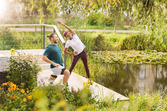 Two people are playing frisbee in a park.