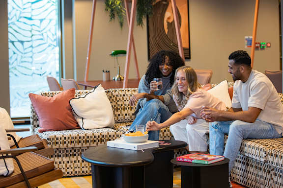 People are sitting on a couch at Emporium House Apartments, Reading