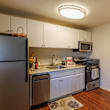 A kitchen with a black stove top oven and a black refrigerator.