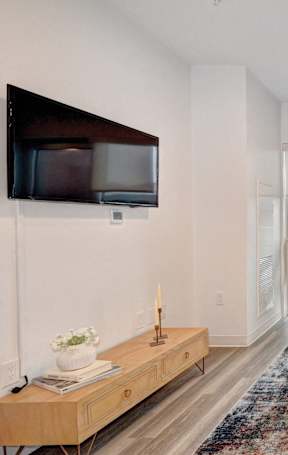 A living room with a white couch and a wooden table.