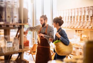 a man and a woman in a grocery store with a basket of food at The Palms, Charleston, South Carolina