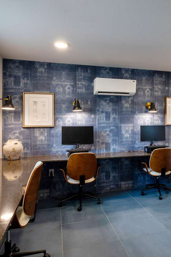 A reception area with a piano and chairs.