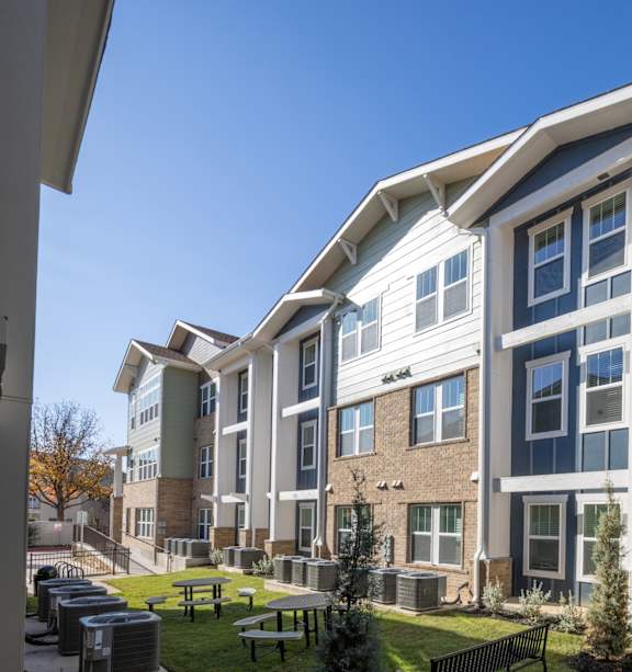 Apartment building with a car parked in front.