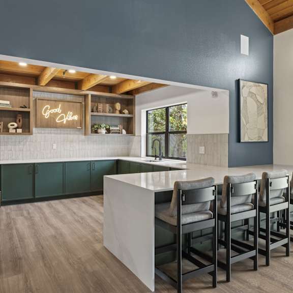 a living room filled with furniture and a large flat screen tv at The Lakes Apartments, Washington