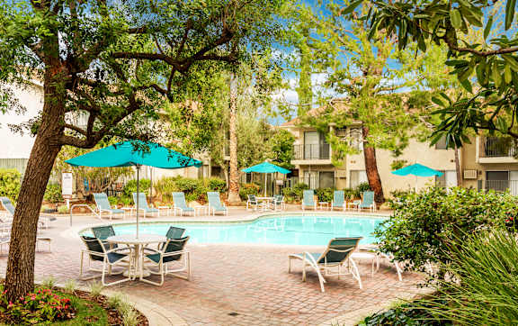 a balcony with a table and chairs and a view of the beach at Village Pointe Apartments, Northridge, CA, 91325