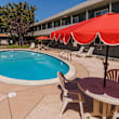 A small pool in a courtyard surrounded by buildings.