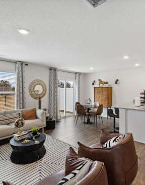 A living room with a couch, chairs, and a coffee table at The Summit Townhomes in Oak Ridge, Tennessee