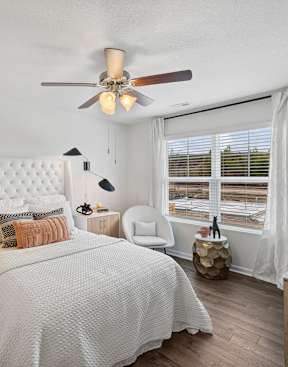 A bedroom with a large bed and a ceiling fan at The Summit Townhomes in Oak Ridge, TN