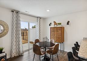 A dining room with a round table and chairs. at The Summit Townhomes in TN 37830