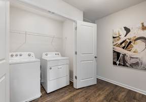 A laundry room with a washer and dryer and a door at The Summit Townhomes in Oak Ridge, TN 37830