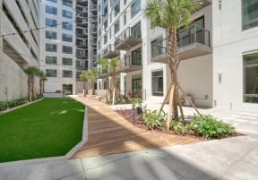 a courtyard with trees and grass in front of an apartment building at Vista Brooklynn Apartments, Jacksonville, Florida