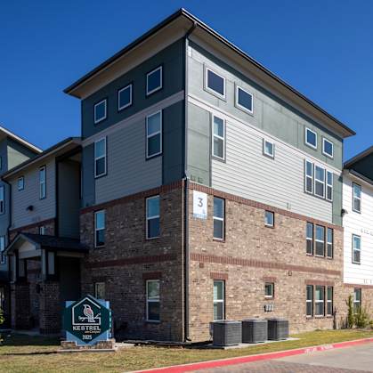 A row of apartment buildings with a sign that says "Neighborhood".