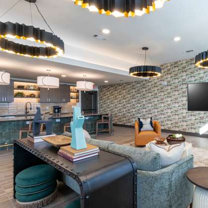 A modern living room with a brick wall and a flat screen TV.