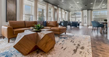 a lobby with couches and a table on a rug at CityView, North Kansas City, MO, 64116