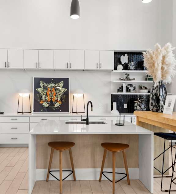 A modern kitchen with a large island and bar stools. at Bridge at Tech Crossing, Austin, TX, 78753