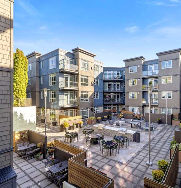 A sunny day at a courtyard surrounded by buildings.
