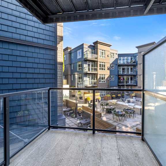 an empty living room with two large windows at 128 on State, WA, 98033