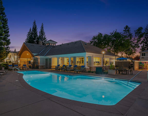 Resort-style swimming pool at dusk - Preserve at Blue Ravine Apartments