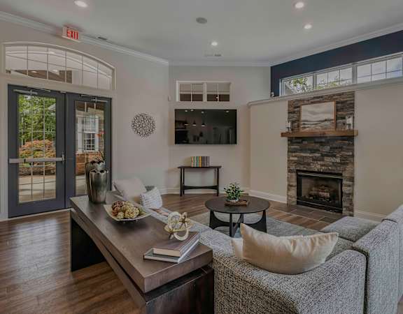 Clubhouse lounge area with fireplace - Lantern Woods Apartments