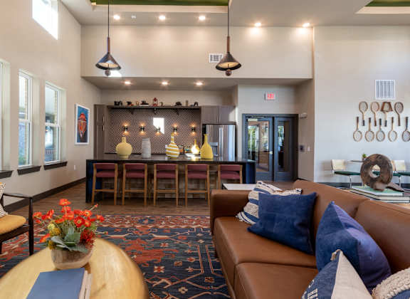 A living room with a brown couch and a wooden coffee table.