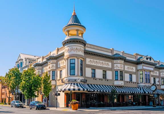A large building with a tower and striped awning. at Creekview Homes, Chico, CA, 95928